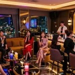 Engaged guests enjoying the vibrant atmosphere at www.3no.org's unique karaoke lounge in Incheon, featuring luxury decor and colorful lighting.